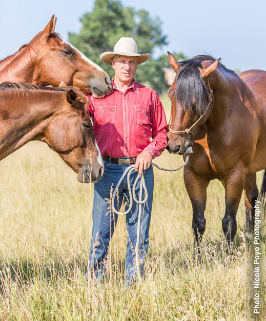 Buck Brannaman with horses in a field — Photo © Nicole Poyo Photography