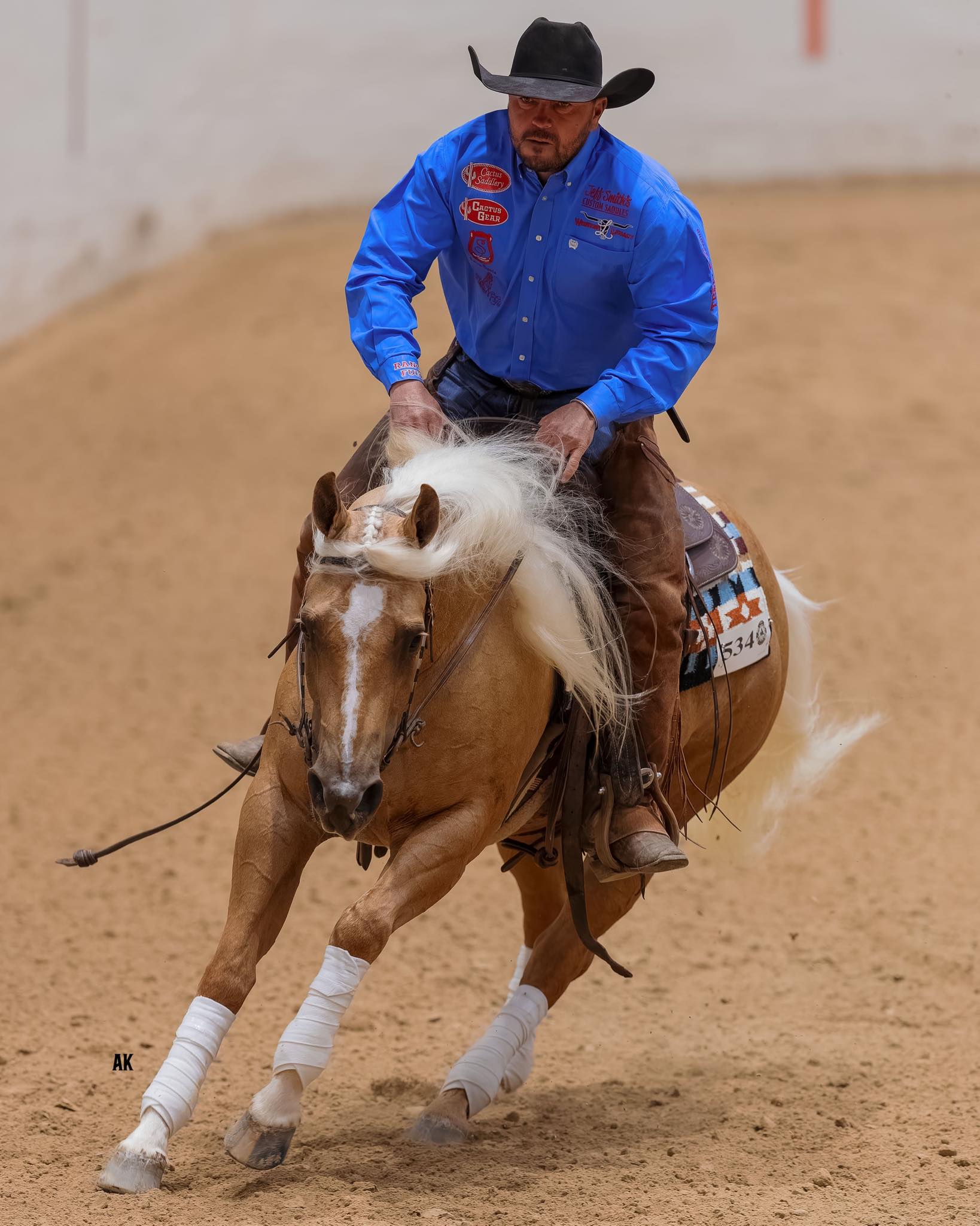 Justin Wright competing in reined cow horse — photo © AK