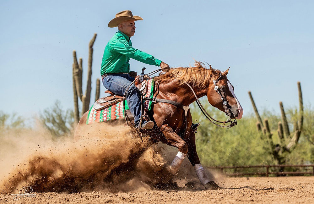 Matt Mills executing a sliding stop in Arizona desert reining